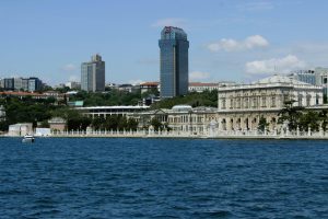 View of Dolmabahçe Palace and Istanbul skyline from the Bosphorus on a clear day.